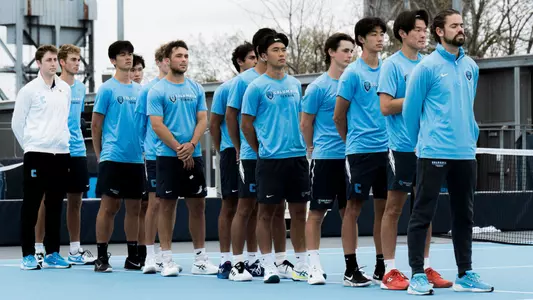 Men's Tennis lines up prior to a match