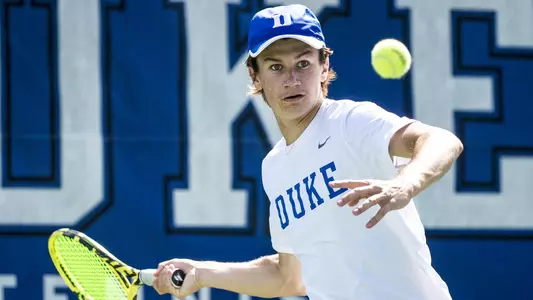 Garrett Johns returns a ball with his forehand