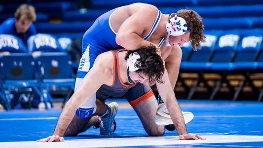 Ben Anderson takes down Cam Coy of Virginia via a pin to earn six points for Duke