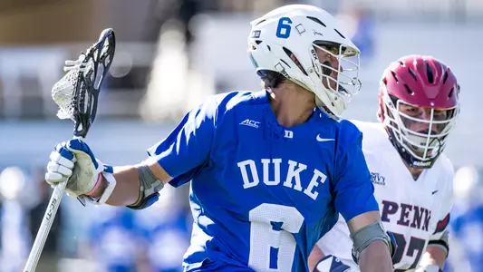 Jake Caputo runs past a Penn player