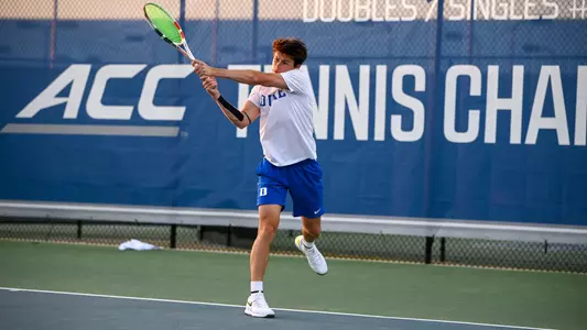 Garrett Johns follows through on a hit during his match against Louisville