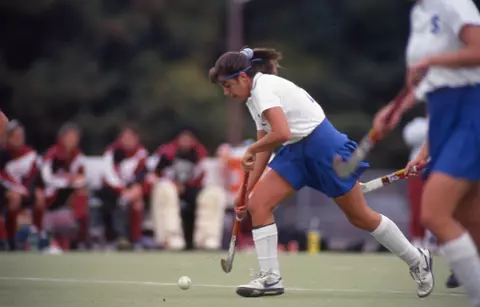 Laura Gentile dribbles down the field hockey field