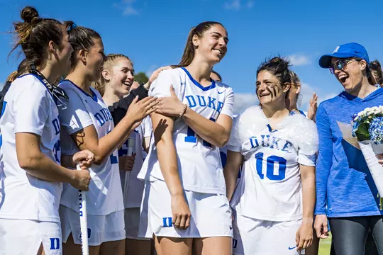 Maddie Jenner celebrates breaking the NCAA single-season draw control record with her Duke women's lacrosse teammates.