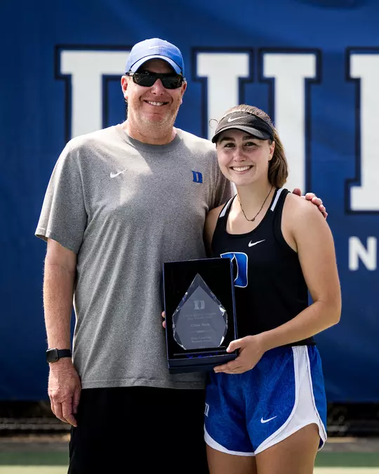 Head coach Jamie Ashworth and Chloe Beck pose for a photo after Beck received the women's team MVP award.