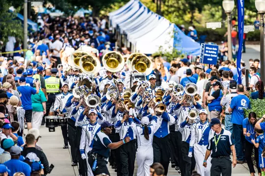 The Duke marching band walks through DevilsGate before a home football game in 2018