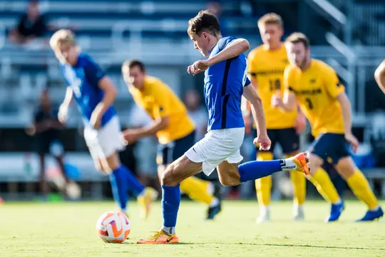 Peter Stroud kicks the ball during a Duke men's soccer home game.