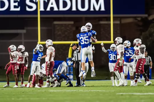 Cam Dillon celebrates a play with a Duke football teammate at Wallace Wade Stadium