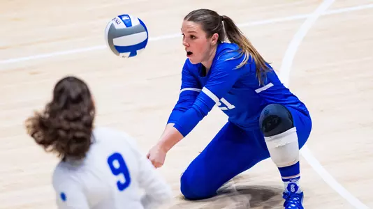 Madison Bryant digs a ball at Cameron Indoor Stadium.