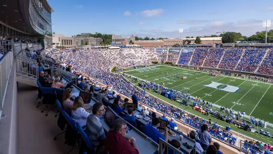 Fans enjoy a Duke football game from the DeJoy Family Club