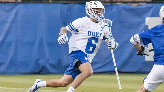 Jake Caputo runs past an Air Force player