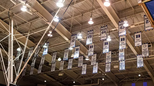 Retired jerseys hang in the Cameron Indoor Stadium rafters