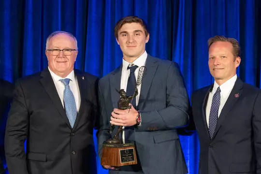 Duke's Brennan O'Neill holds the 2023 Tewaaraton Trophy