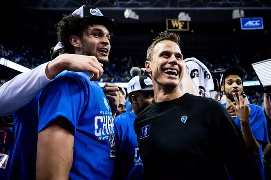 First-year head coach Jon Scheyer celebrates the 2023 ACC Championship with Dereck Lively II