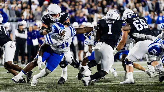 Kendy Charles makes a tackle at Northwestern.