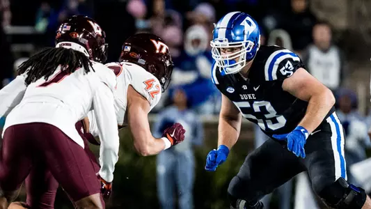 Brian Parker blocks Virginia Tech defenders.