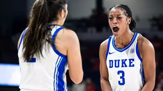 Duke women's basketball Ashlon Jackson celebrates with teammate Vanessa de Jesus