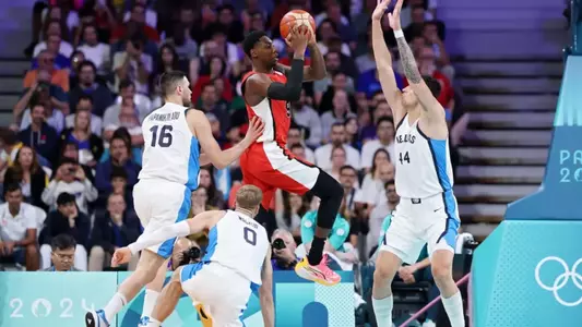 LILLE, FRANCE - JULY 27: Rj Barrett #9 of Team Canada passes the ball past Konstantinos Mitoglou #44 of Team Greece while Kostas Papanikolaou #16 and Thomas Walkup #0 of Team Greece defend during the Men's Group Phase - Group A game between Greece and Canada on day one of the Olympic Games Paris 2024 at Stade Pierre Mauroy on July 27, 2024 in Lille, France. (Photo by Gregory Shamus/Getty Images)