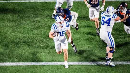 Duke tight end Jeremiah Hasley, wearing a white helmet, white jersey and white pants, crosses the goal line with the ball in his arms for a touchdown on Duke's opening drive versus No. 16 Virginia in the 2025 ACC Championship Game.