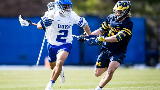 Andrew McAdorey of Duke runs past Michigan defenseman