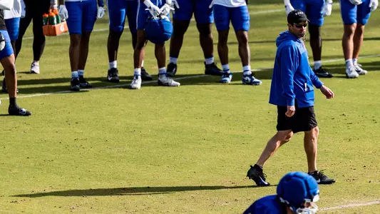 Head coach Manny Diaz walks and observes during a spring football practice.