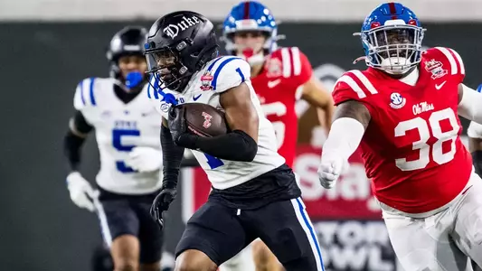 Terry Moore runs down the field with an interception against Ole Miss in the Gator Bowl.