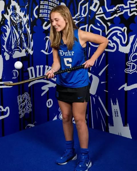 Sydney Beare juggling field hockey ball with her stick in a posed studio photo