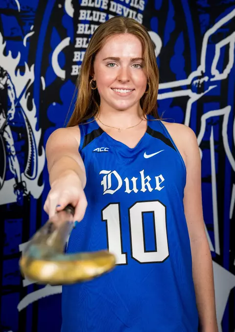 Duke field hockey player points her stick at the camera