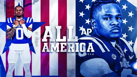 Duke All-America cornerback Chandler Rivers poses in front of an American flag backdrop with arms crossed and looks at the camera.