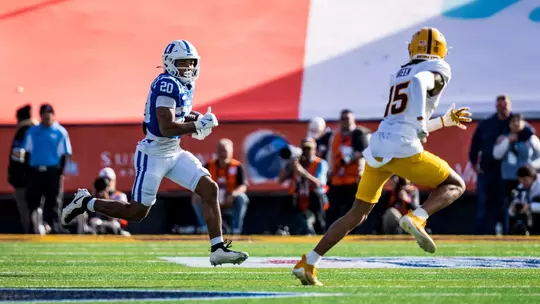 Duke running back Nate Sheppard, wearing a white helmet, blue jersey and white pants, runs towards the end zone during the 2025 Tony the Tiger Sun Bowl, which Duke won 42-39 against Arizona State inside Sun Bowl Stadium.