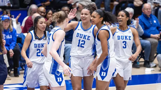 Members of the Duke women's basketball team exchange high fives in celebration during the team's victory against Notre Dame on January 4, 2026.