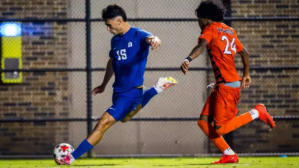 Ari Racaj crosses the ball for Duke men's soccer