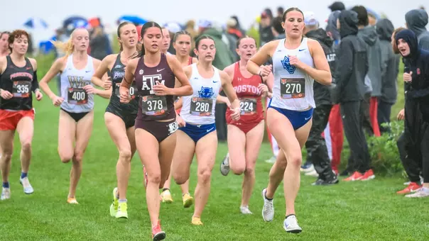 Anna Callahan runs at the front of a pack in a XC race.