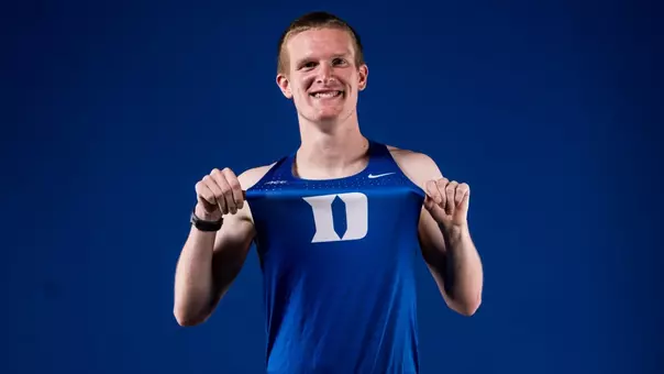 Arthur Graham poses in cross country uniform showing off his jersey