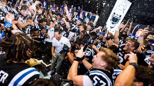 The Duke football team celebrated in the locker room following its 21-20 comeback win against North Carolina to return the Victory Bell to Durham.