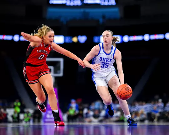 Duke’s Toby Fournier drives past a Louisville defender during the ACC women’s basketball championship game.