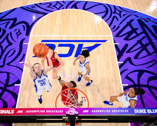 Toby Fournier fights for a rebound while players from Duke and Louisville battle for position beneath the basket during the ACC championship game.