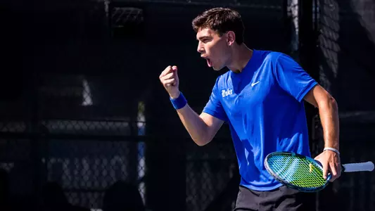 Duke's Teddy Truwit, wearing a blue shirt and black shorts, celebrates with a fist pump during Duke's quarterfinal ACC Championship match against Wake Forest at the Cary Tennis Park on April 17, 2026.