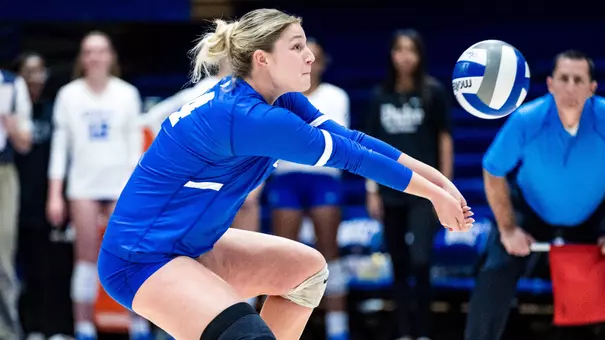 Duke volleyball's Sydney Tomlak digs a ball in a game.