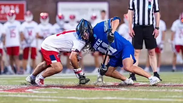Cal Girard wins a faceoff against University of Richmond