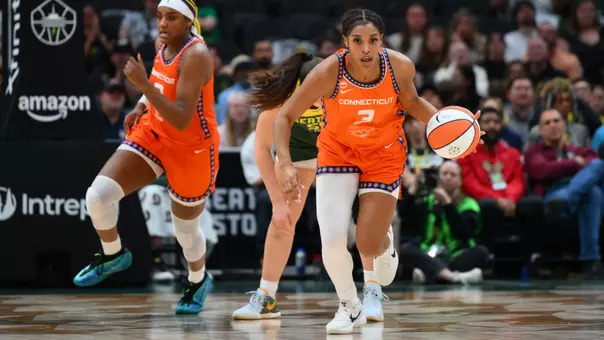 Ashlon Jackson dribbles the basketball in a Connecticut Sun orange uniform