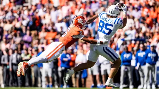 Duke tight end Jeremiah Hasley, wearing a white helmet, jersey and pants, hauls in a pass at Clemson on November 1, 2025.