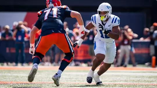 Duke defensive end Bryce Davis, wearing a white helmet, white jersey and white pants, reacts to the snap and runs towards the ball during Duke's 31-27 victory at Illinois on September 12, 2026.