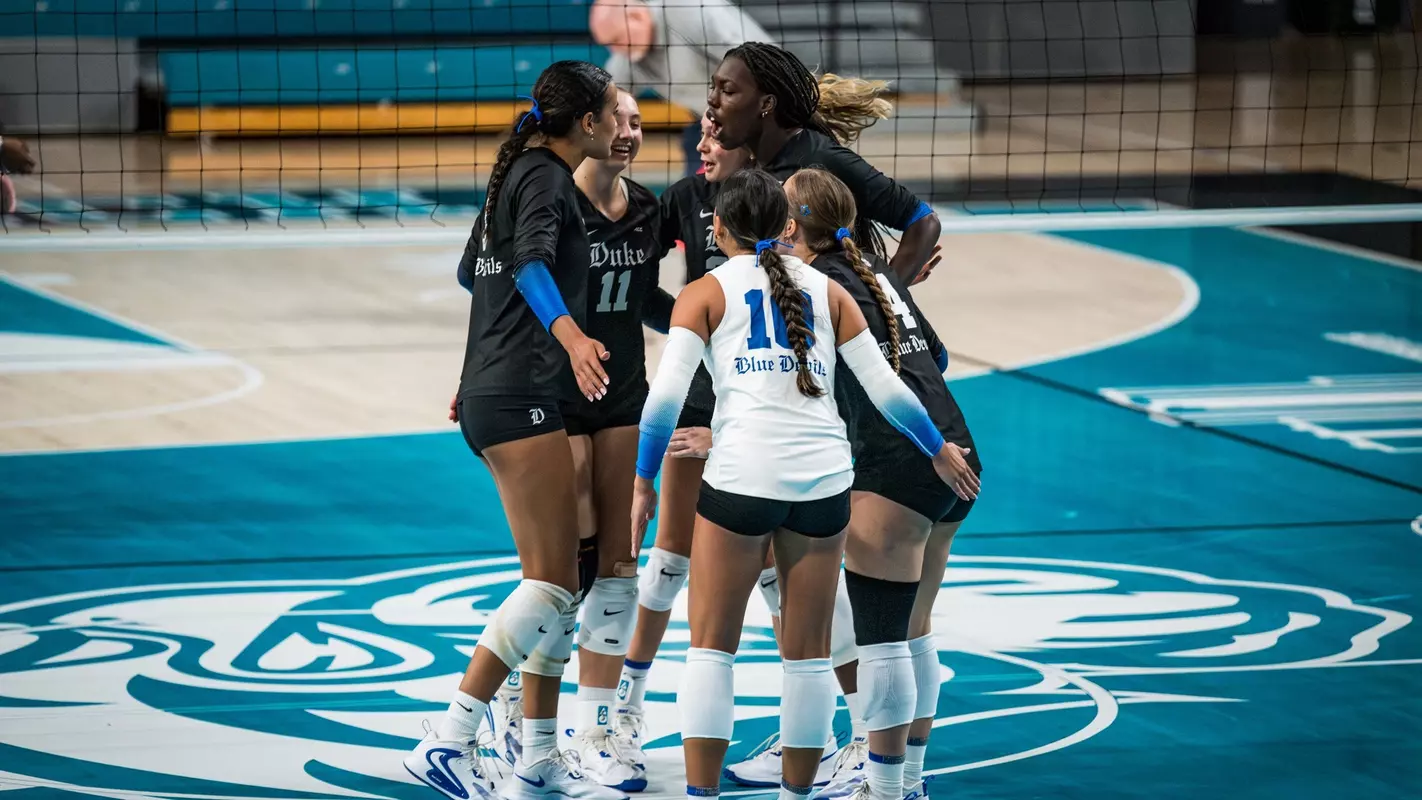 Duke volleyball players warming up on the court