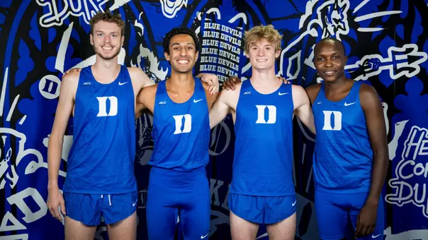 Four Duke men's cross country runners pose together