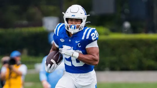 Duke running back Nate Sheppard, wearing a white helmet, blue jersey and white pants, holds the ball and runs against Tulane on September 5, 2026.