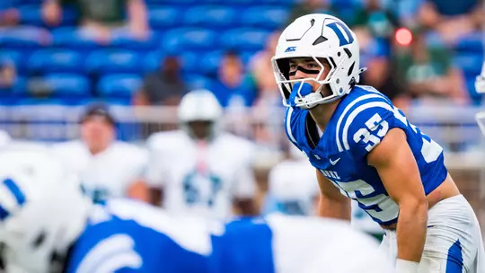 Duke safety Andrew Pellicciotta, wearing a white helmet, blue jersey and white pants, looks toward the ball before a snap in the 2026 season opener against Tulane.