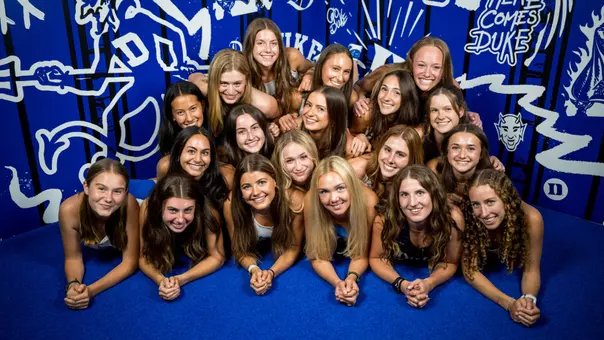 2026 Women's Cross Country Team in casual photo in front of Duke designed wall