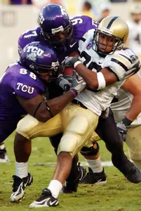 Army's Carlton Jones (30) is stopped by TCU's Ranorris Ray (88) and Tommy Blake (97) during the first half of TCU's win.