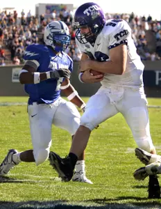 Jeff Ballard jumps into the end zone for a touchdown against Air Force linebacker Overton Spence during the second quarter. (AP Photo/Jack Dempsey)