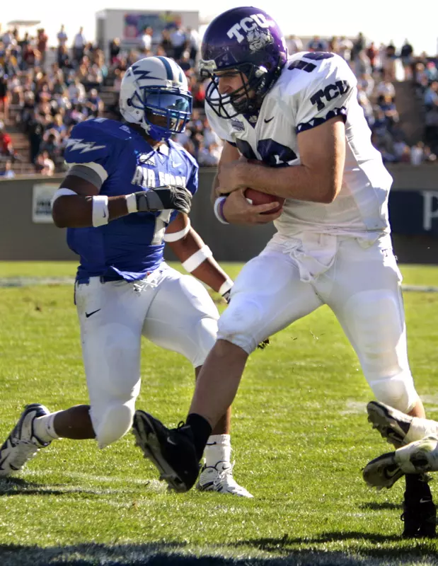 Jeff Ballard jumps into the end zone for a touchdown against Air Force linebacker Overton Spence during the second quarter. (AP Photo/Jack Dempsey)